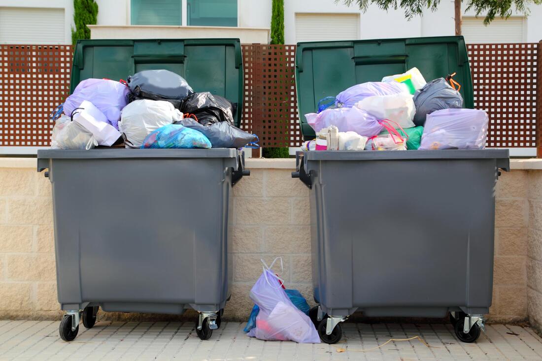 garbage bins with over flowing junk/garbage